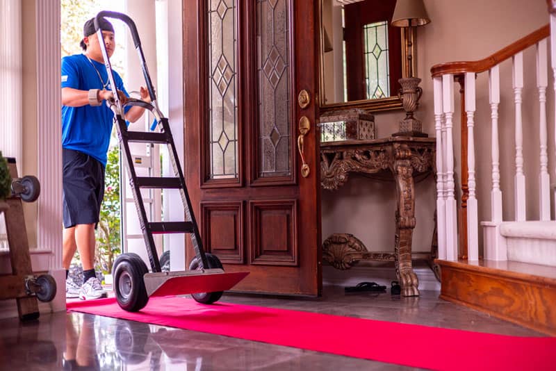 Movers with a dolly at a Sugar Land apartment