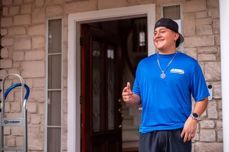 Smiling mover at the front door of a Sugar Land home