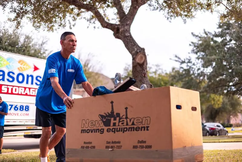 Mover wheeling boxes to the moving truck in Sugar Land