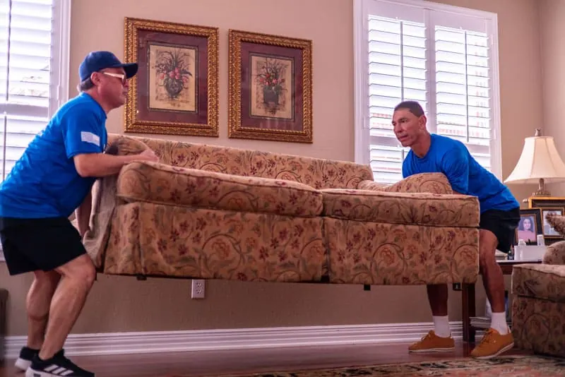 Movers carrying a sofa in Sugar Land, TX