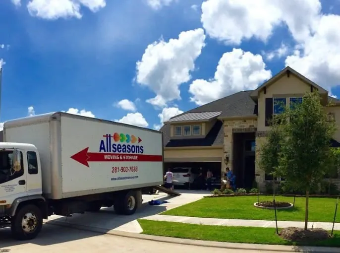 Moving truck parked at a two-story home in Sugar Land, TX
