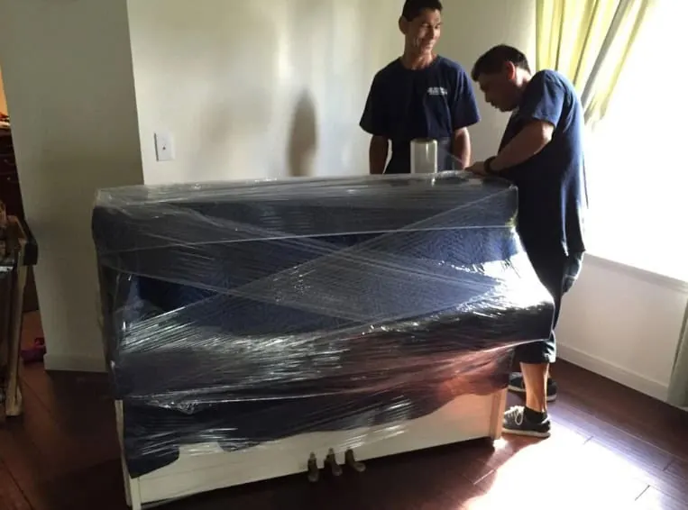 Wrapped piano ready to move in a Sugar Land home
